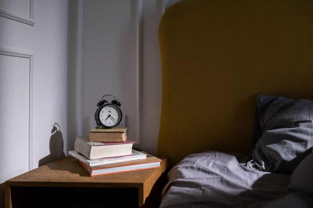 Alarm clock on a bedside table, a reminder to fall back an hour when daylight saving time ends