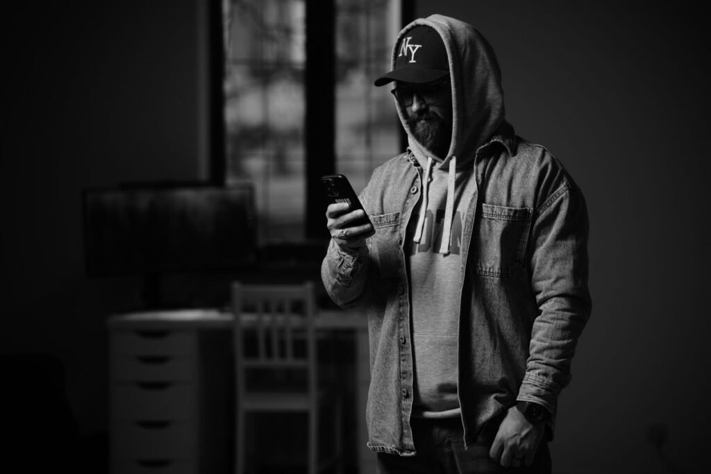 Person checking unread notifications on a phone in a dark room