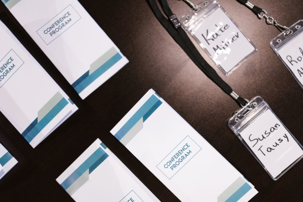 Conference name badges on a table, where many new names are introduced at once