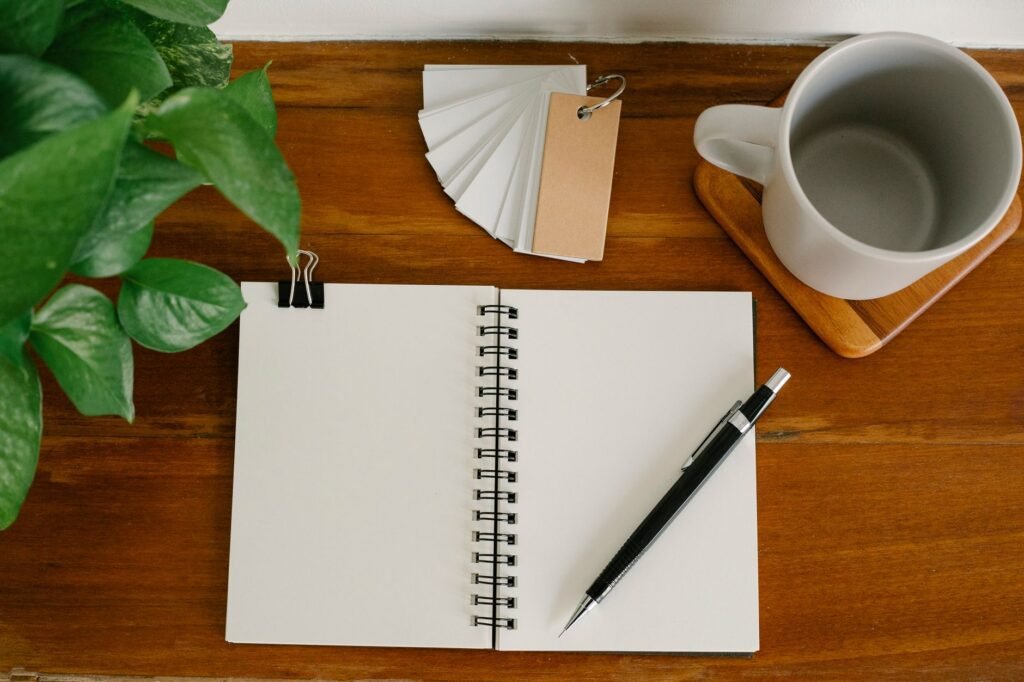 Open notebook and pen on a desk, useful for tracking your own mood triggers
