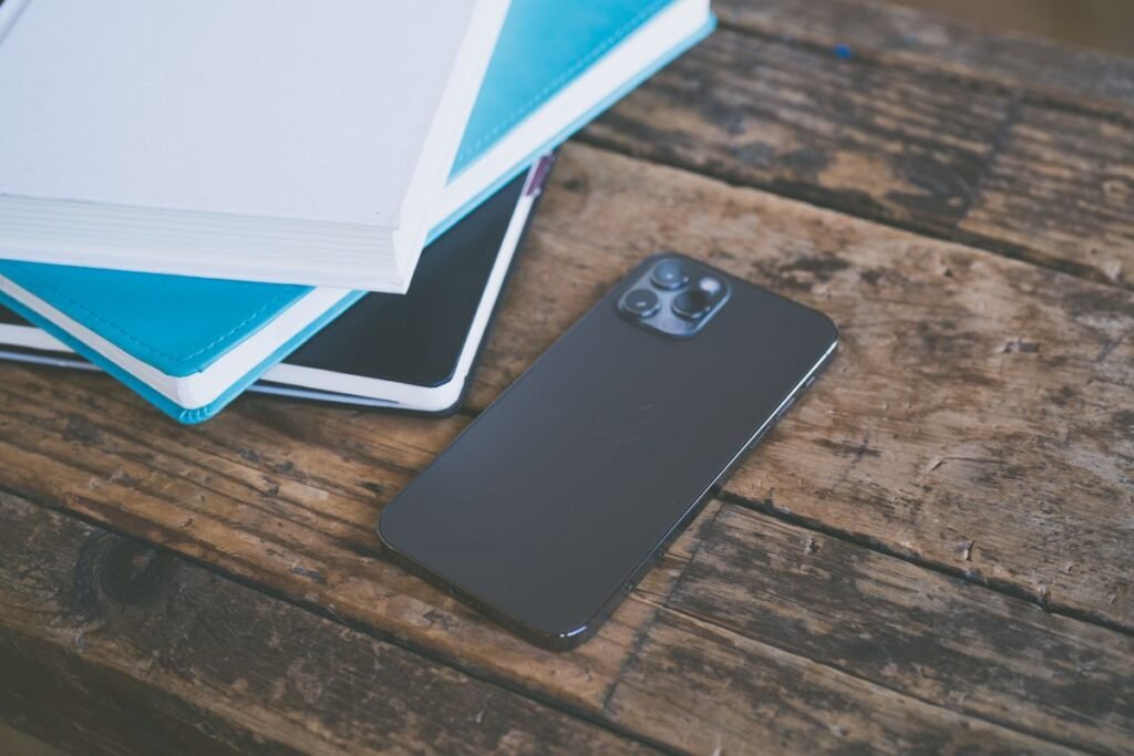 Phone set aside next to notebooks to cut down notification overload
