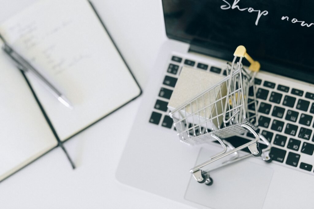 Small shopping cart on a laptop, like items saved in an online cart