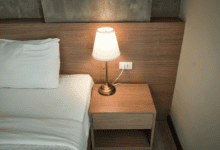Bedside lamp glowing in a dark bedroom, the quiet scene when waking up at 3am