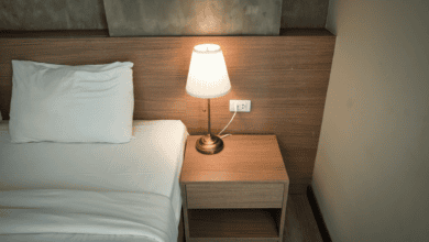 Bedside lamp glowing in a dark bedroom, the quiet scene when waking up at 3am