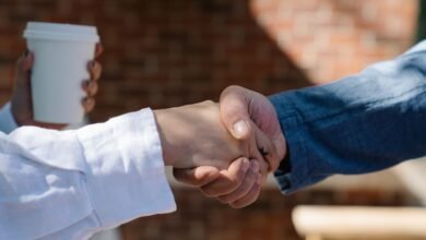 Two people shaking hands, the moment you ask why do I forget names so fast