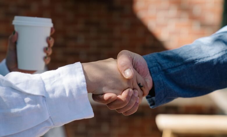 Two people shaking hands, the moment you ask why do I forget names so fast